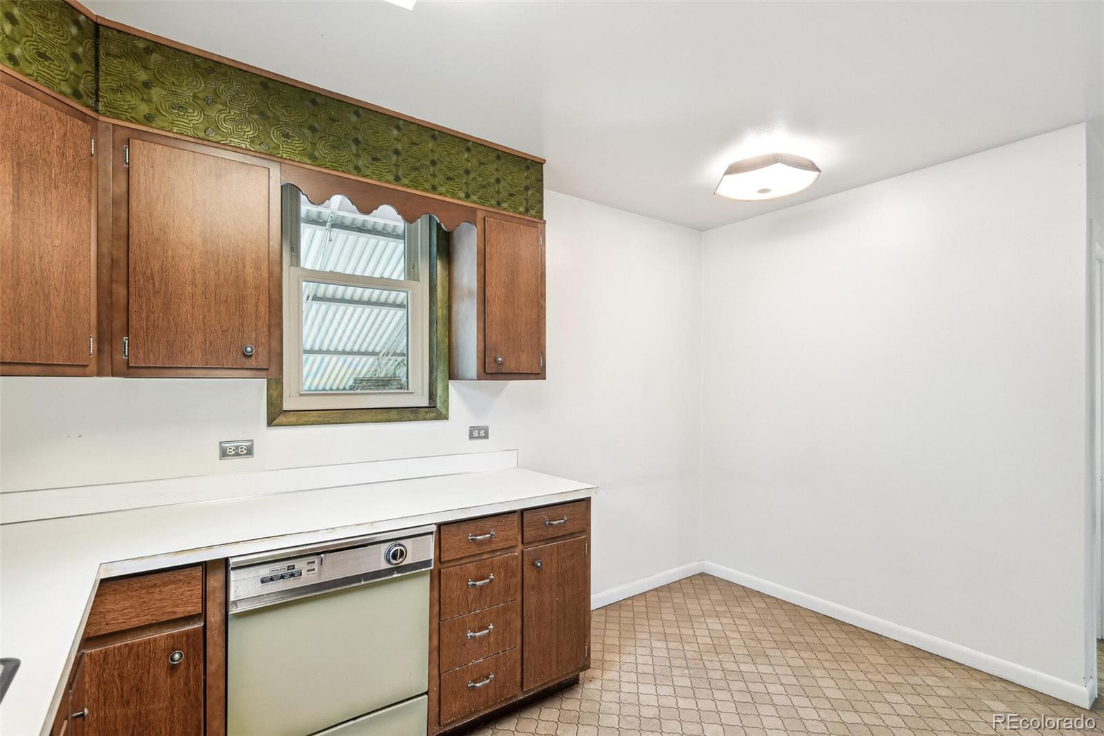 3921 Meade Street Denver, CO 80211 - Photo 15 of 27 a view of a kitchen cabinets a sink and a window