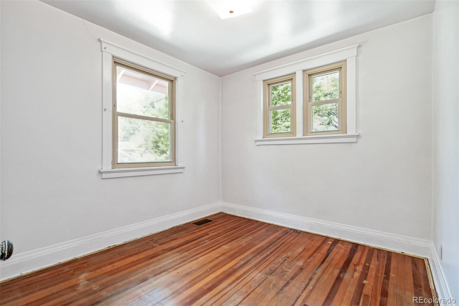 3921 Meade Street Denver, CO 80211 - Photo 19 of 27 an empty room with wooden floor and windows