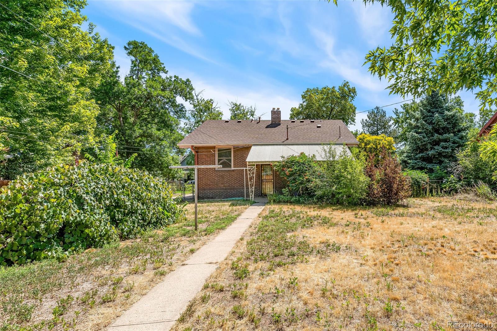 3921 Meade Street Denver, CO 80211 - Photo 25 of 27 a front view of a house with a yard