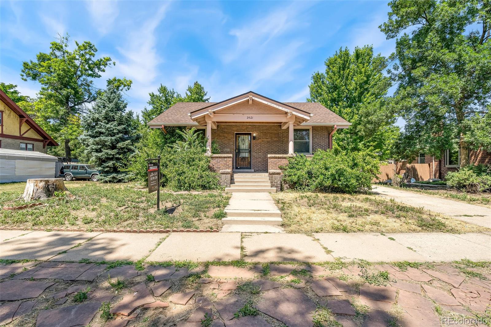 3921 Meade Street Denver, CO 80211 - Photo 4 of 27 a front view of a house with a yard