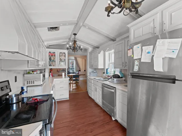 a kitchen with a stove sink and cabinets