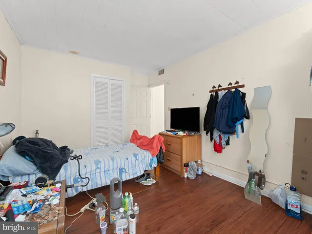 a view of a livingroom with wooden floor and furniture