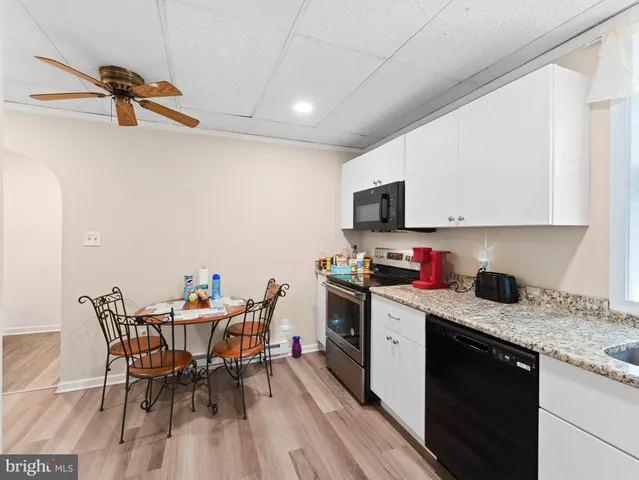 a kitchen with a sink appliances and cabinets
