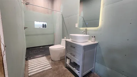 a kitchen with a refrigerator and table chairs