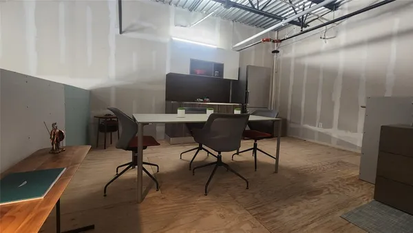 a workspace with furniture and wooden floor