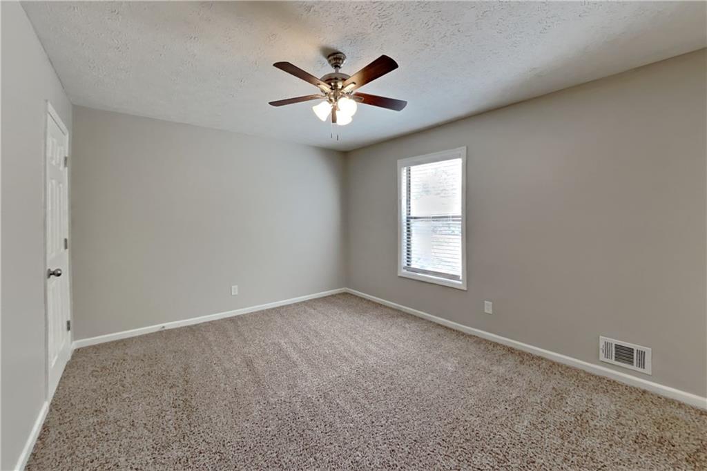 6015 Sumit Court Northwest Kennesaw, GA 30152 - Photo 14 of 24 an empty room with window and ceiling fan