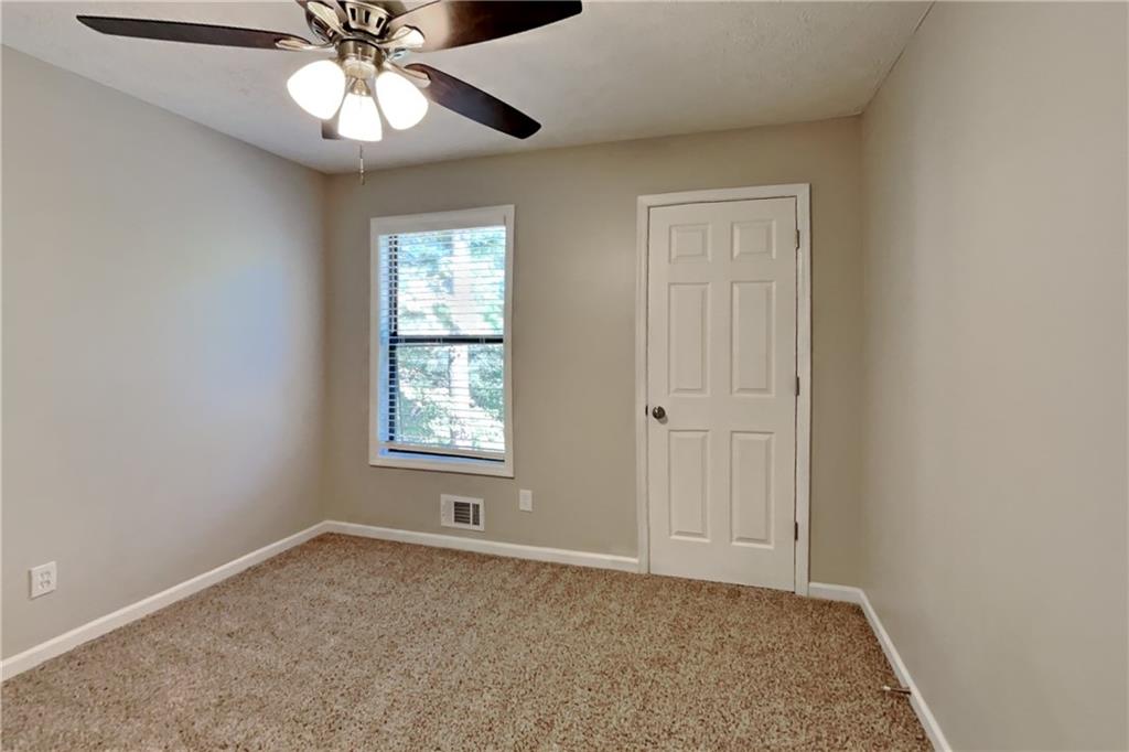 6015 Sumit Court Northwest Kennesaw, GA 30152 - Photo 16 of 24 an empty room with a window and a fan