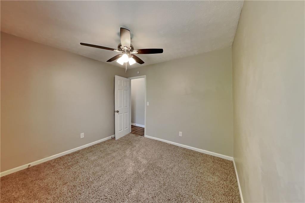 6015 Sumit Court Northwest Kennesaw, GA 30152 - Photo 18 of 24 a view of an empty room with a chandelier fan