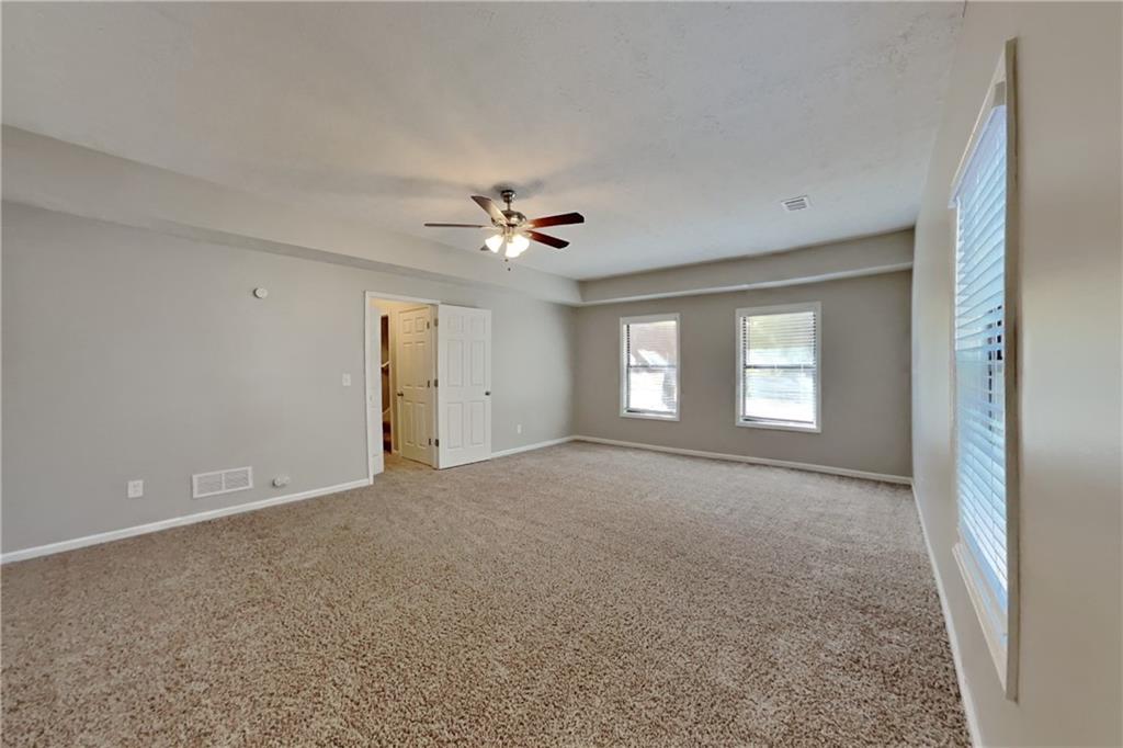 6015 Sumit Court Northwest Kennesaw, GA 30152 - Photo 5 of 24 a view of a livingroom with a ceiling fan and window
