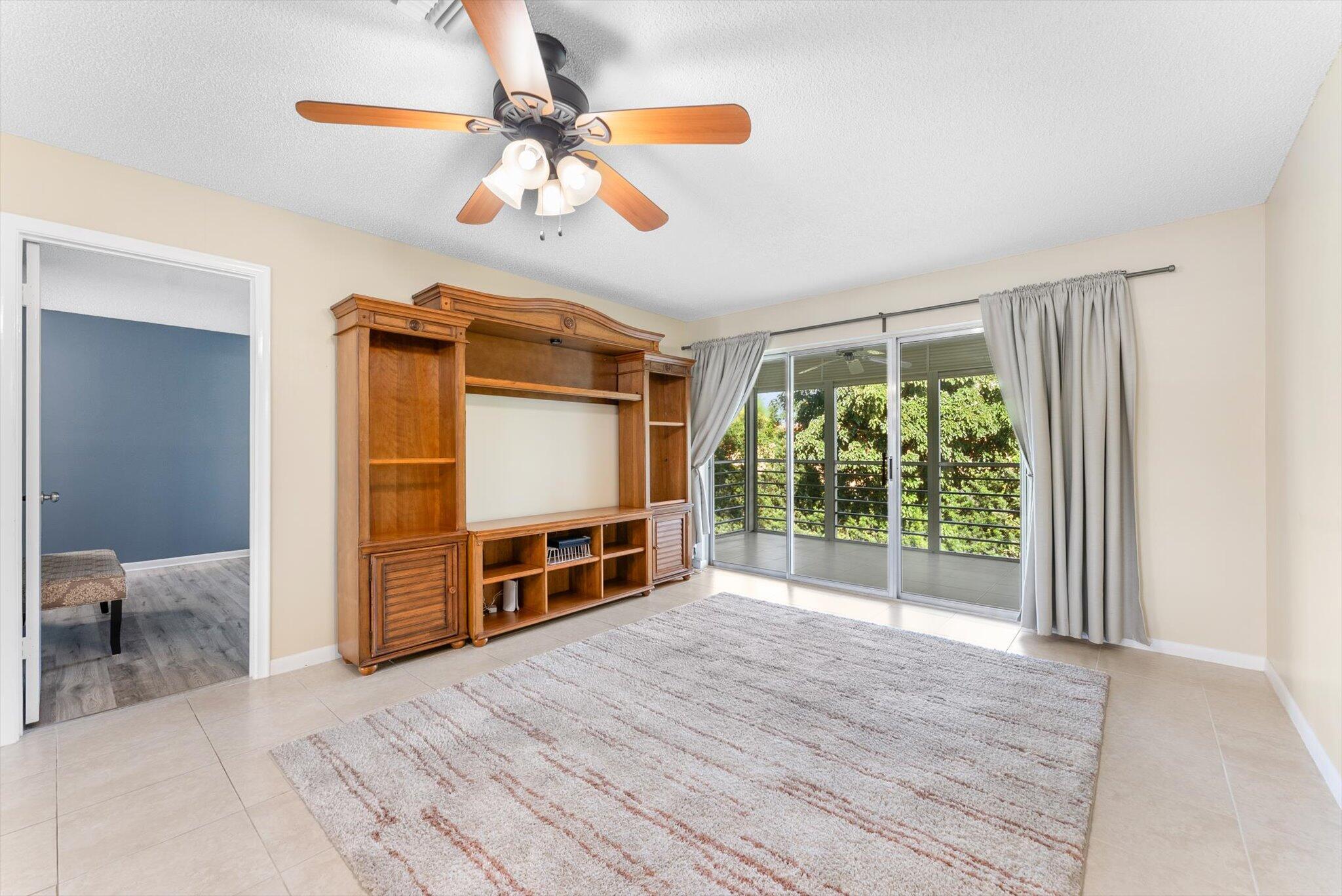 5321 Poppy Place, Unit 203 Delray Beach, FL 33484 - Photo 14 of 31 a view of a livingroom with wooden floor and furniture