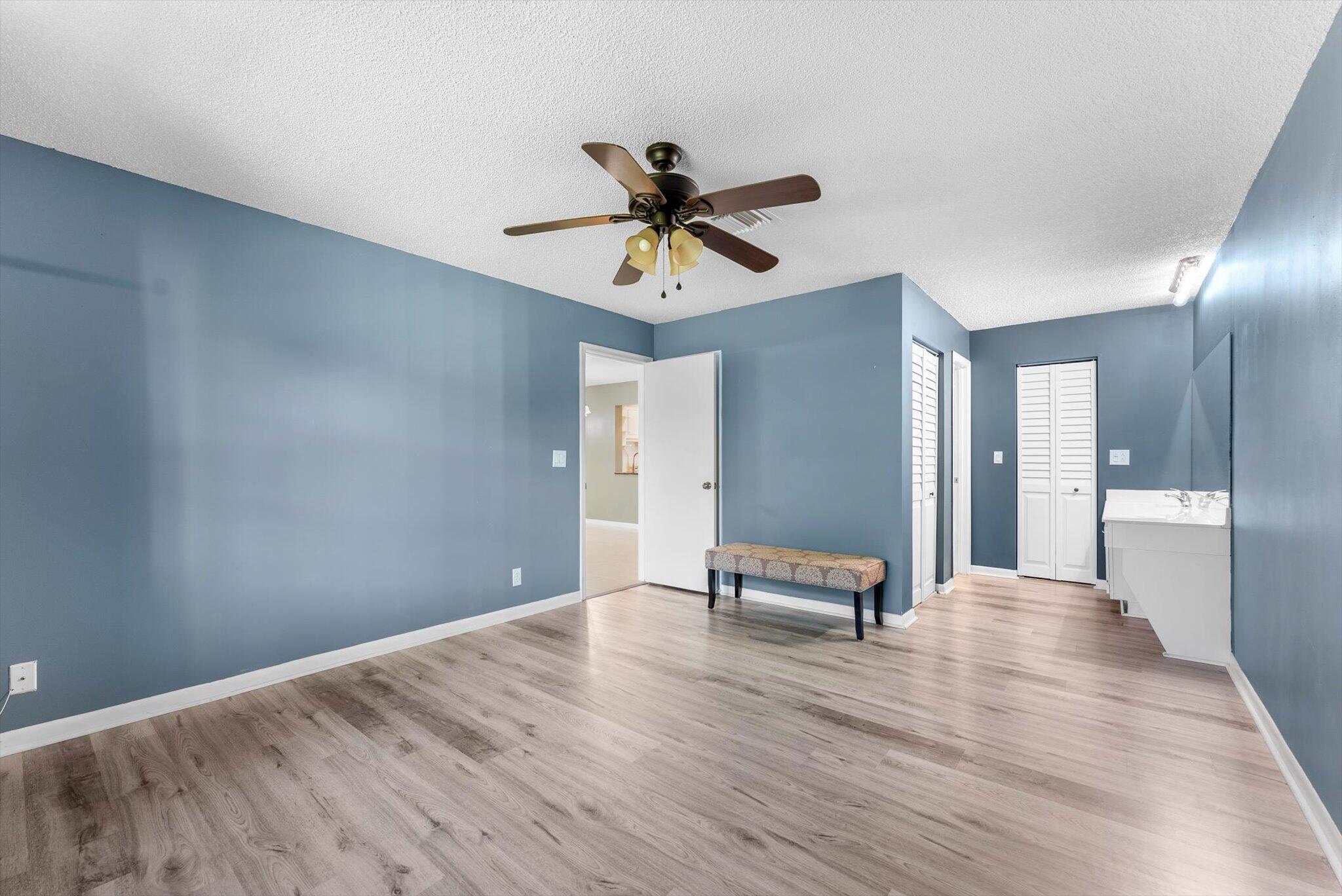 5321 Poppy Place, Unit 203 Delray Beach, FL 33484 - Photo 19 of 31 a living room with furniture and a chandelier