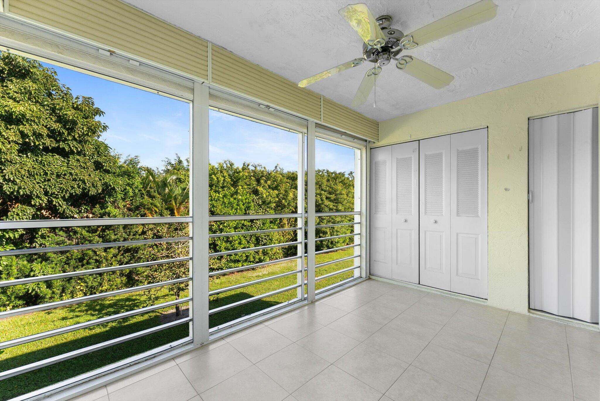 5321 Poppy Place, Unit 203 Delray Beach, FL 33484 - Photo 23 of 31 a view of a room with a large window and a ceiling fan