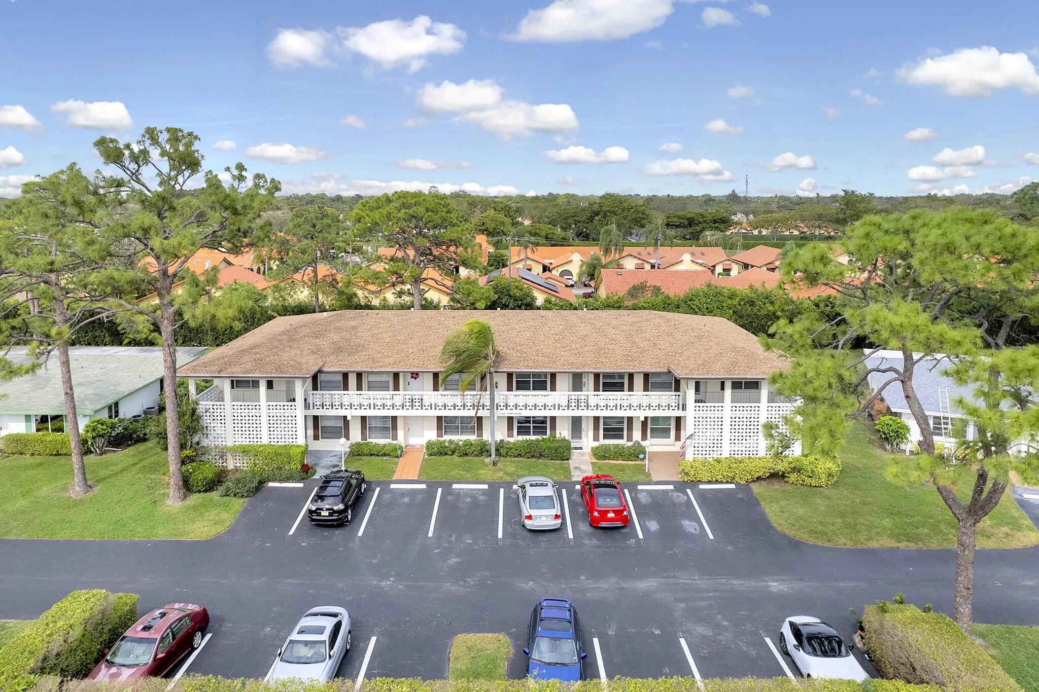 5321 Poppy Place, Unit 203 Delray Beach, FL 33484 - Photo 3 of 31 a view of multiple houses with a yard
