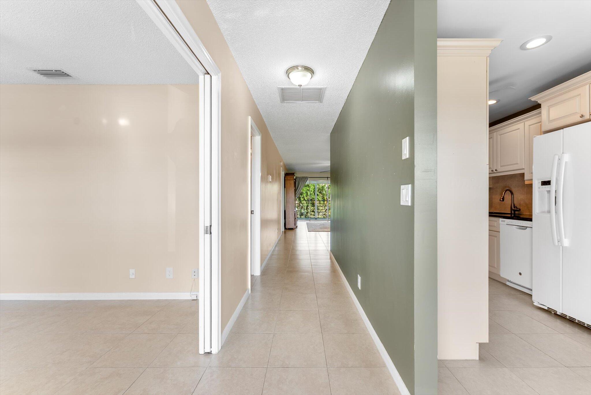 5321 Poppy Place, Unit 203 Delray Beach, FL 33484 - Photo 5 of 31 a view of a hallway with a white walls