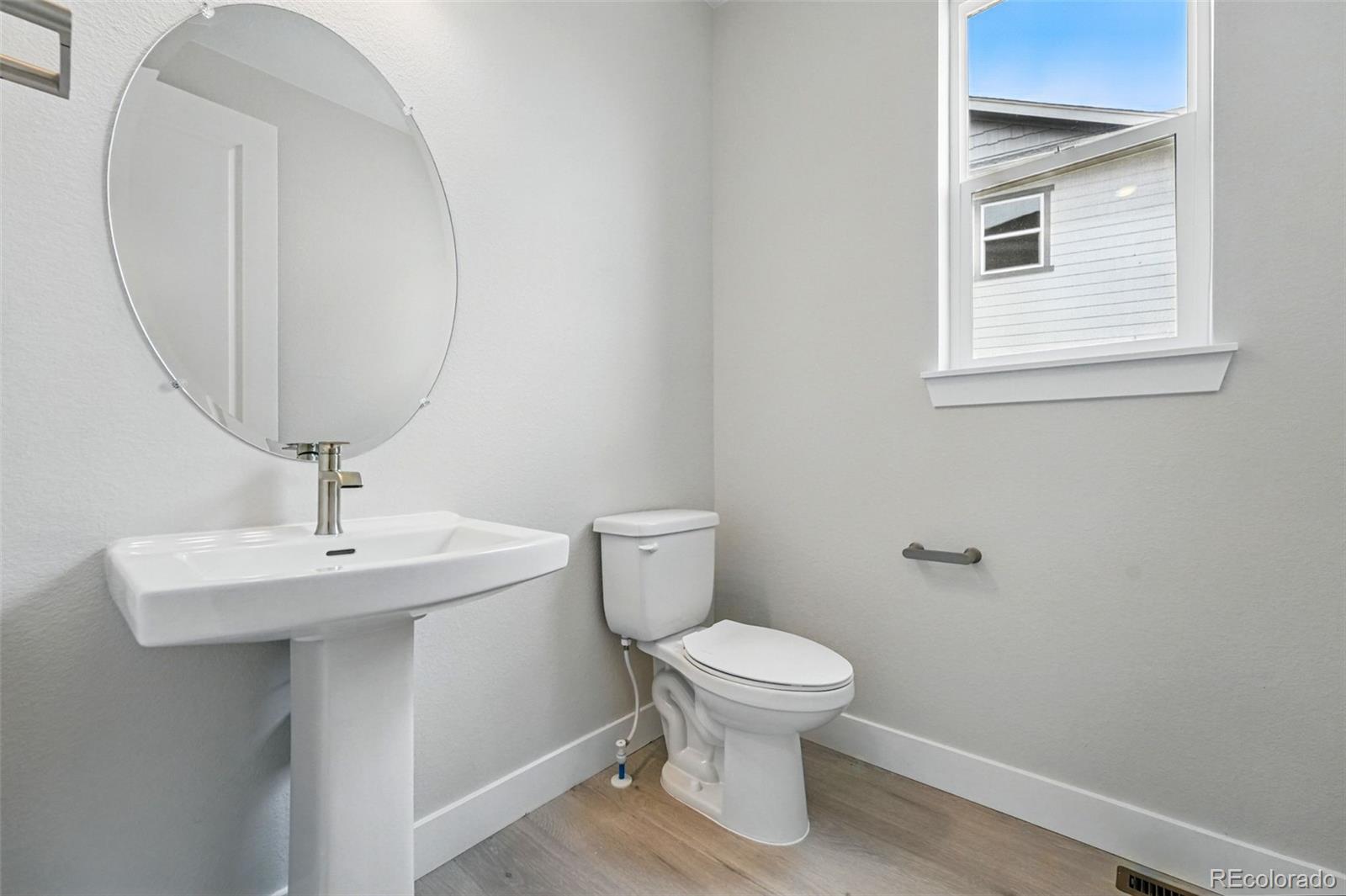 5722 Farrier Point Castle Rock, CO 80104 - Photo 11 of 41 a bathroom with a toilet sink and mirror