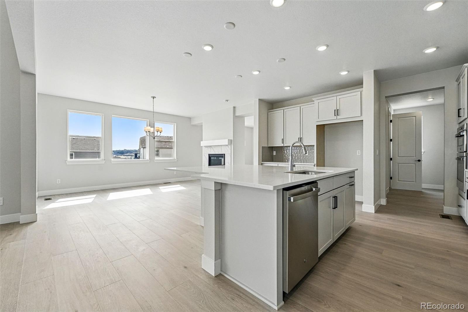 5722 Farrier Point Castle Rock, CO 80104 - Photo 17 of 41 a large kitchen with stainless steel appliances granite countertop a large counter top and a stove