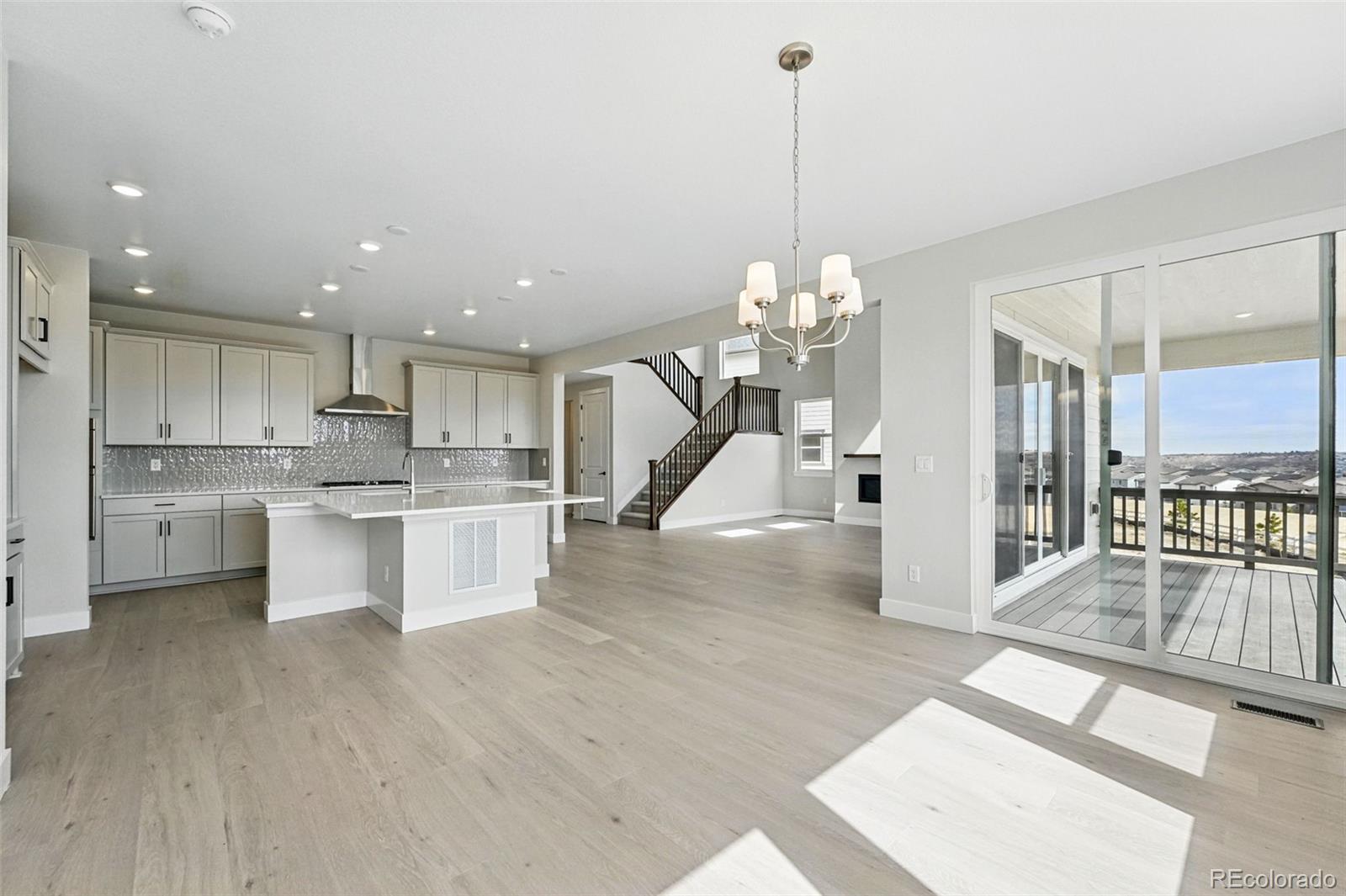 5722 Farrier Point Castle Rock, CO 80104 - Photo 3 of 41 a large white kitchen with lots of counter space wooden floor and appliances