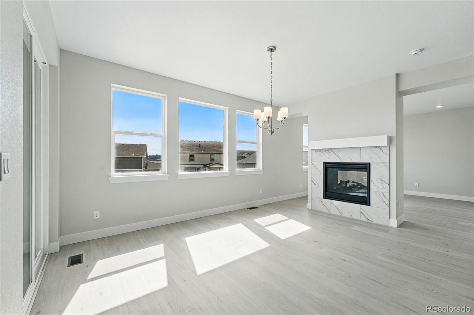 5722 Farrier Point Castle Rock, CO 80104 - Photo 7 of 41 a view of an empty room with a window and fireplace