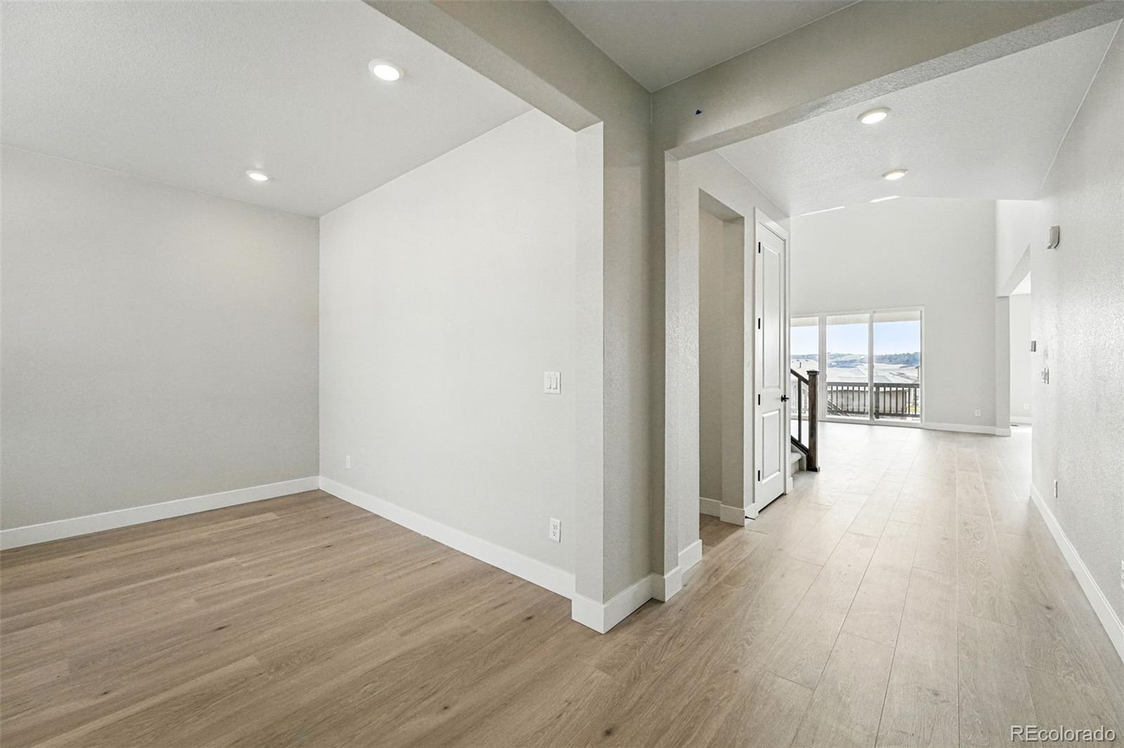 5722 Farrier Point Castle Rock, CO 80104 - Photo 8 of 41 a view of a hallway with wooden floor