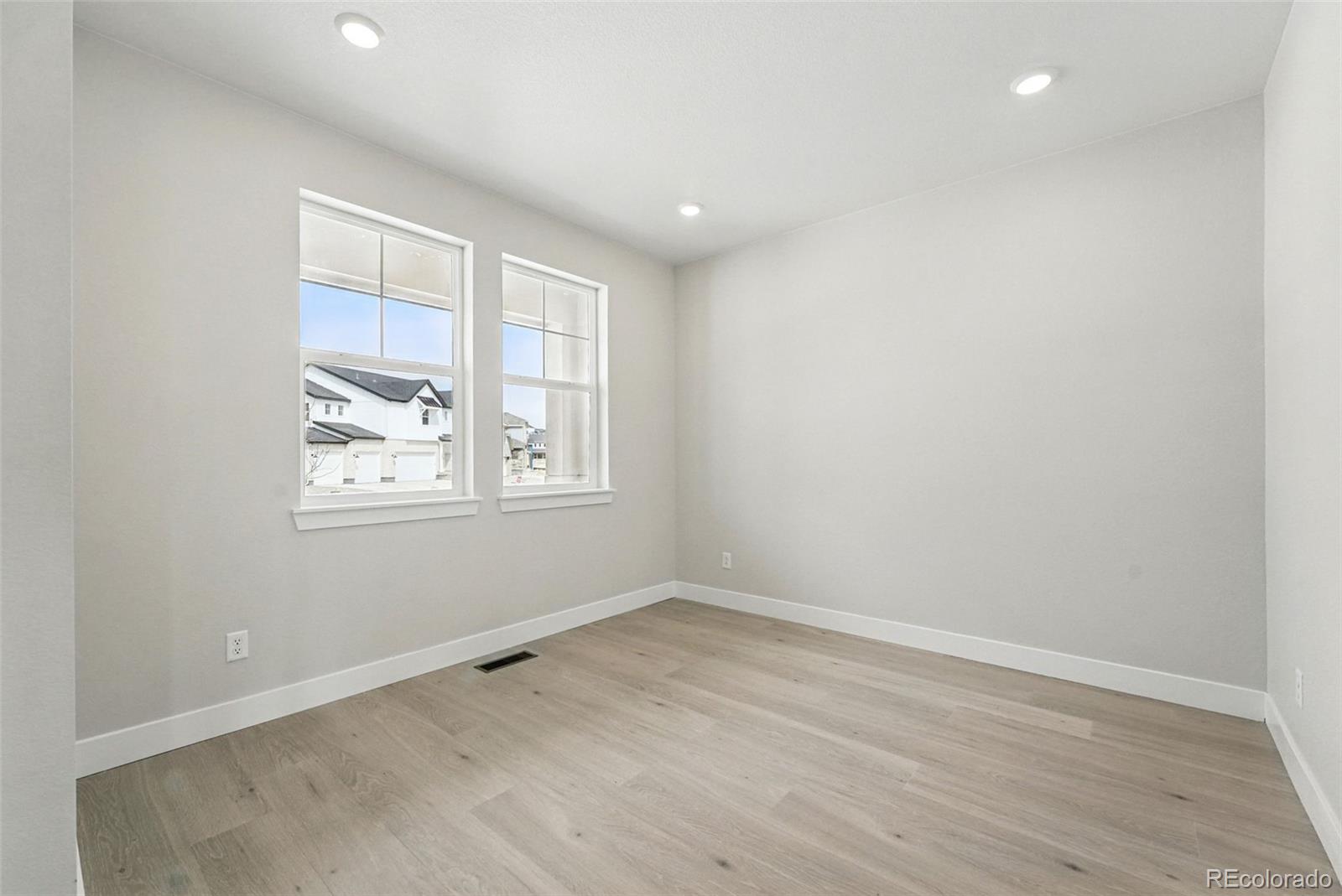 5722 Farrier Point Castle Rock, CO 80104 - Photo 9 of 41 an empty room with wooden floor and windows