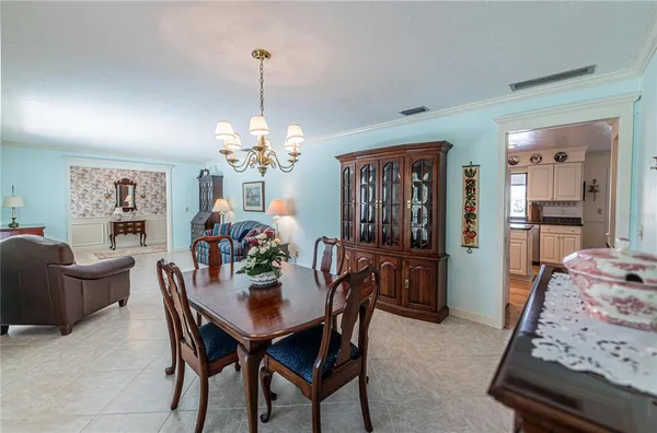 a view of a dining room with furniture and chandelier