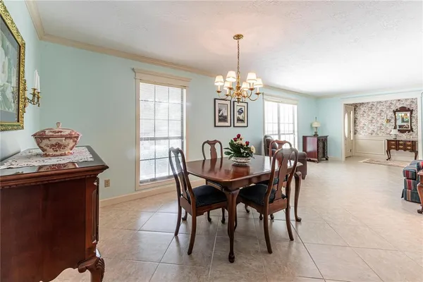 a view of a dining room with furniture and chandelier