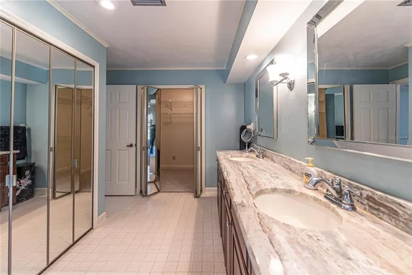 a spacious bathroom with a granite countertop sink and shower