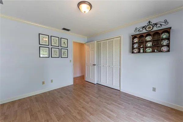 an empty room with wooden floor and window
