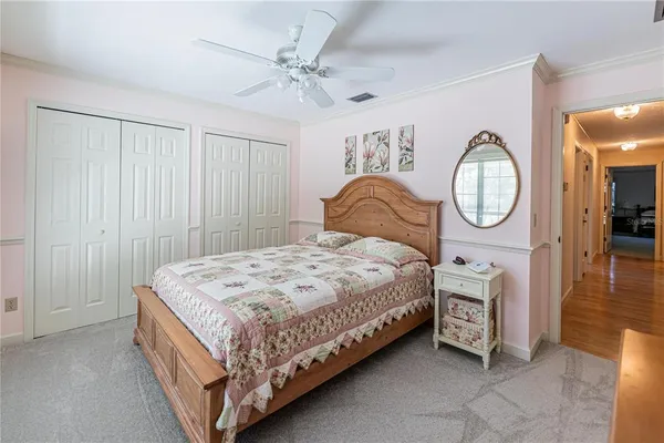 a bedroom with a bed a mirror and a chandelier