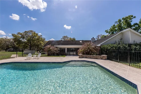 a view of a house with swimming pool and sitting area