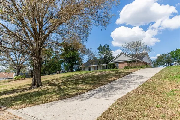a view of a house with a backyard