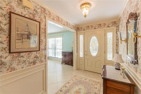 a living room with furniture a large window and wooden floors