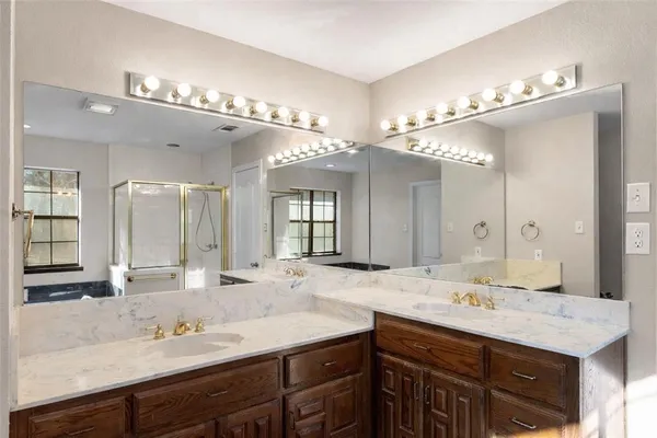 a bathroom with a tub a sink and a window