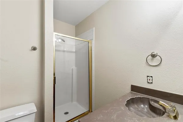a view of a room with an empty space and windows
