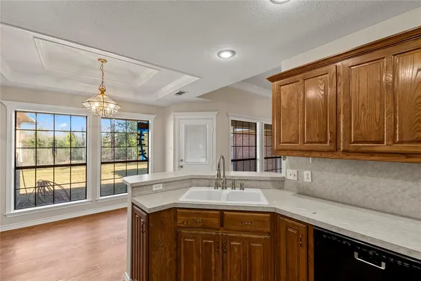 a kitchen with stainless steel appliances granite countertop a sink and a stove