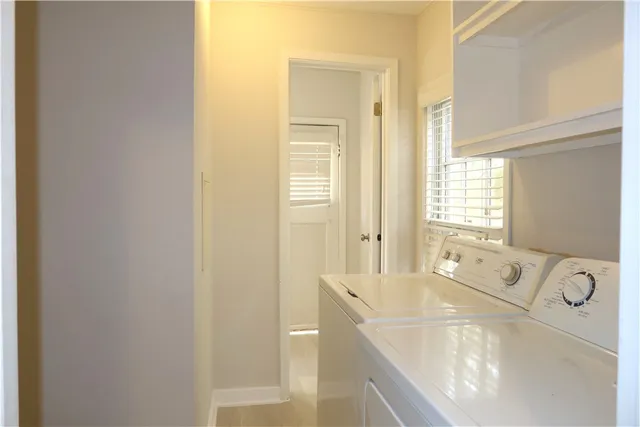 a spacious bathroom with a tub sink and mirror