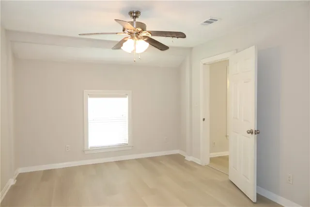 a view of a livingroom with a ceiling fan and window