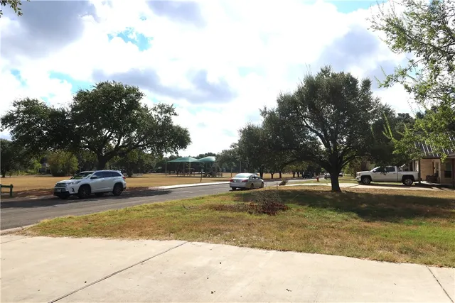 a view of a swimming pool with a yard