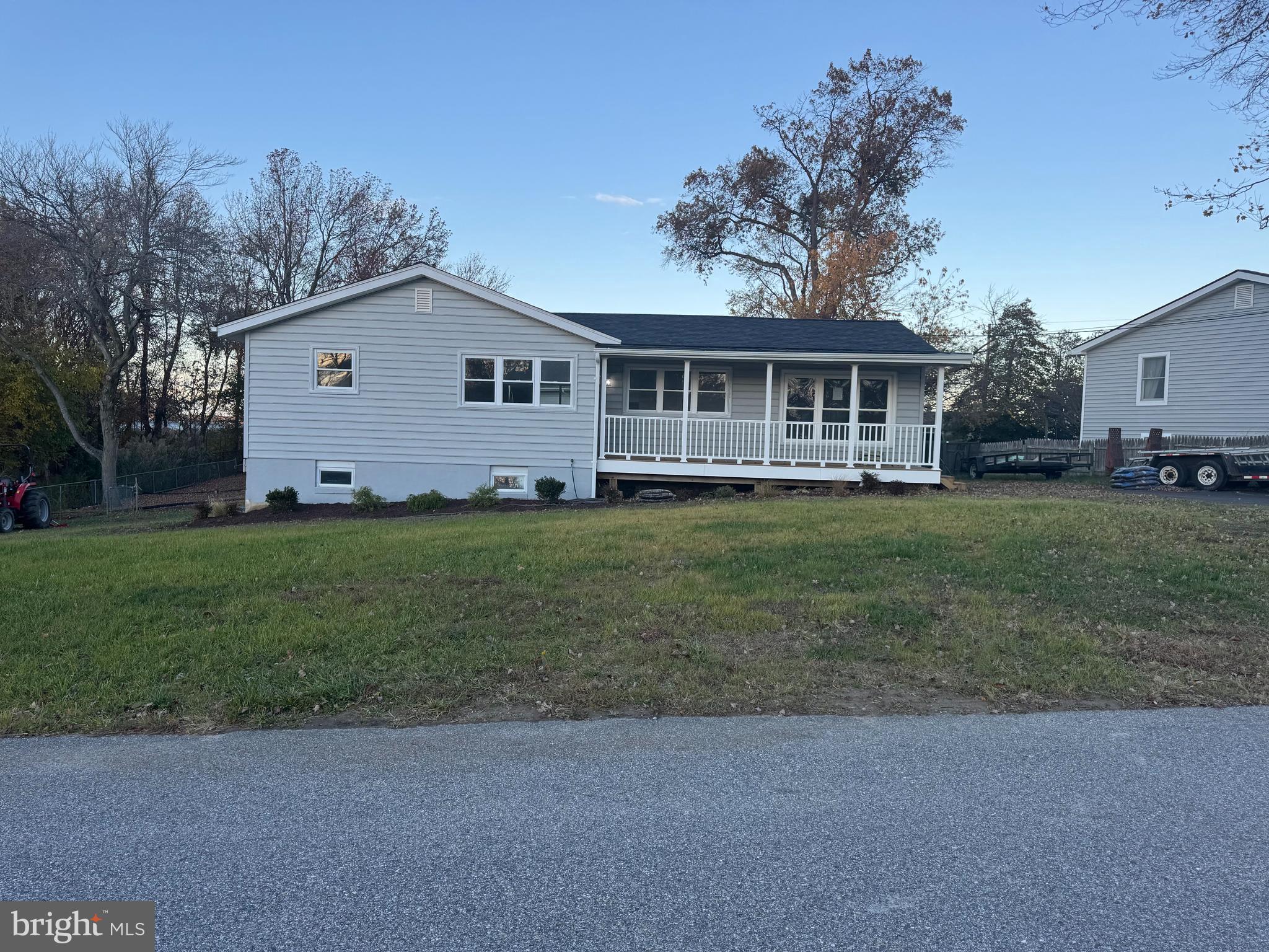 1546 Ridgely Drive Edgewater, MD 21037 - Photo 1 of 2 a front view of a house with a yard and trees