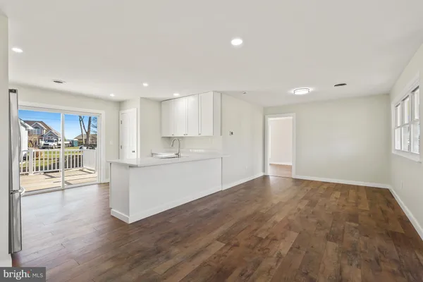 a kitchen with a refrigerator and a sink