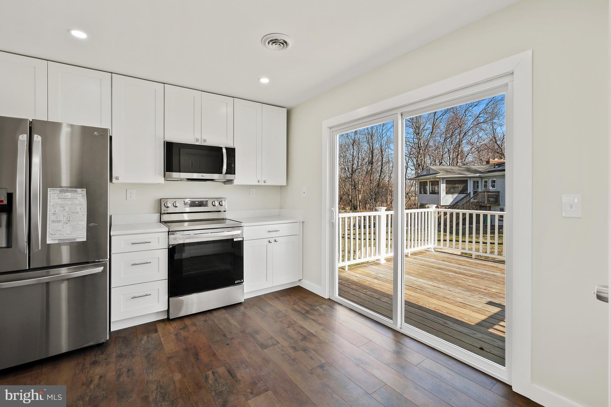 1546 Ridgely Drive Edgewater, MD 21037 - Photo 19 of 55 a kitchen with stainless steel appliances a stove microwave and refrigerator