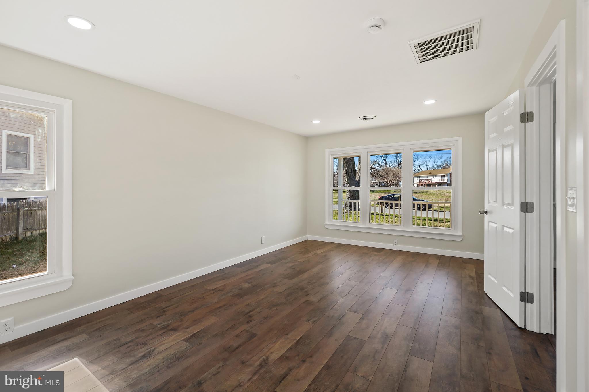 1546 Ridgely Drive Edgewater, MD 21037 - Photo 23 of 55 wooden floor in an empty room with a window