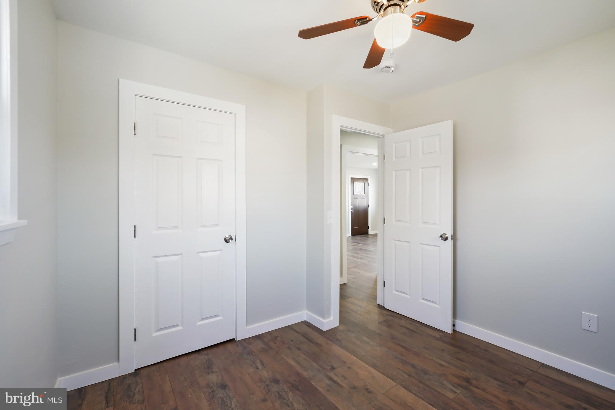 1546 Ridgely Drive Edgewater, MD 21037 - Photo 31 of 55 an empty room with wooden floor ceiling fan and windows