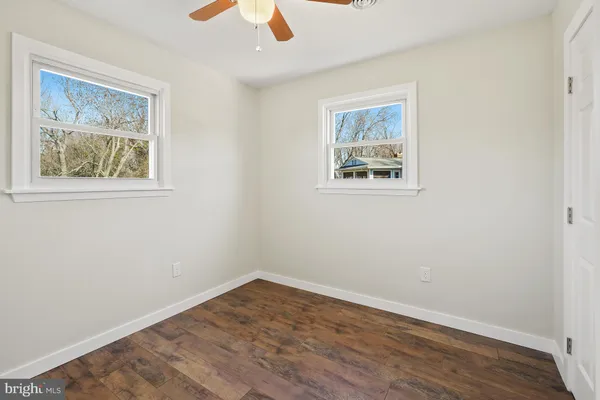 a view of an empty room with wooden floor