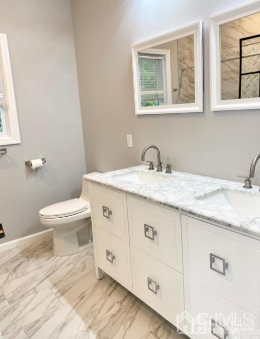10 Idlewild Road Edison, NJ 08817 - Photo 14 of 21 a bathroom with a granite countertop toilet sink and mirror