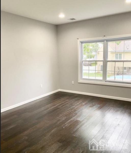 10 Idlewild Road Edison, NJ 08817 - Photo 15 of 21 an empty room with wooden floor and windows