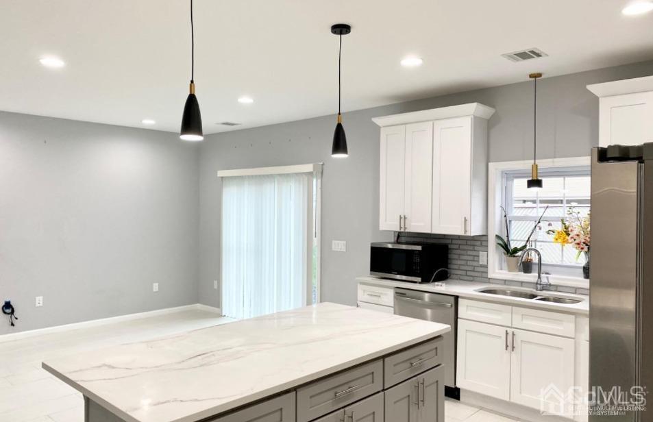 10 Idlewild Road Edison, NJ 08817 - Photo 4 of 21 a kitchen with stainless steel appliances sink stove refrigerator and cabinets