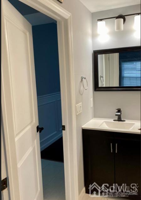 10 Idlewild Road Edison, NJ 08817 - Photo 7 of 21 a bathroom with a sink a mirror and a toilet