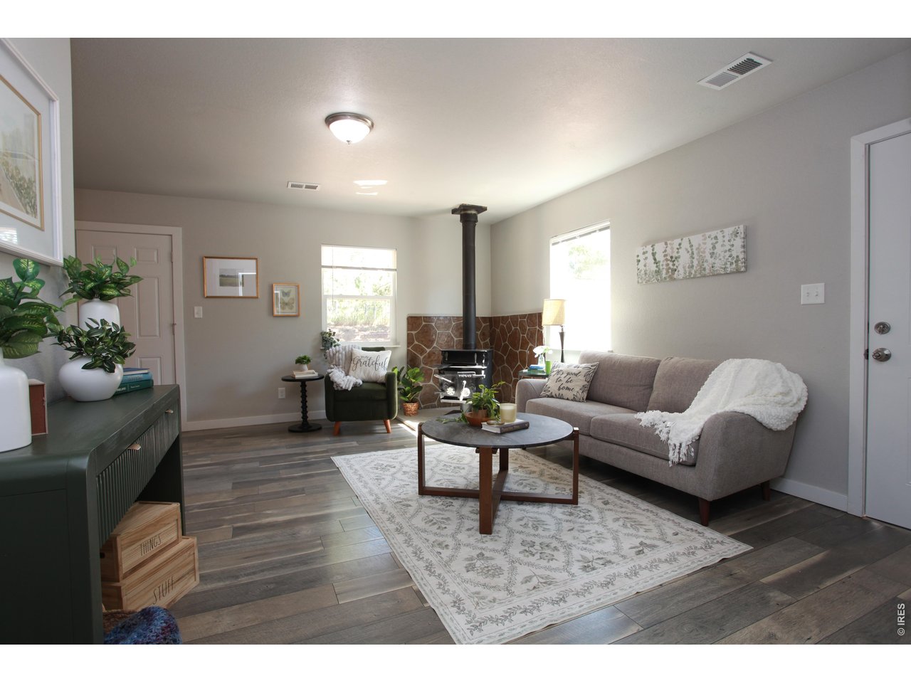 a living room with furniture potted plant and a window