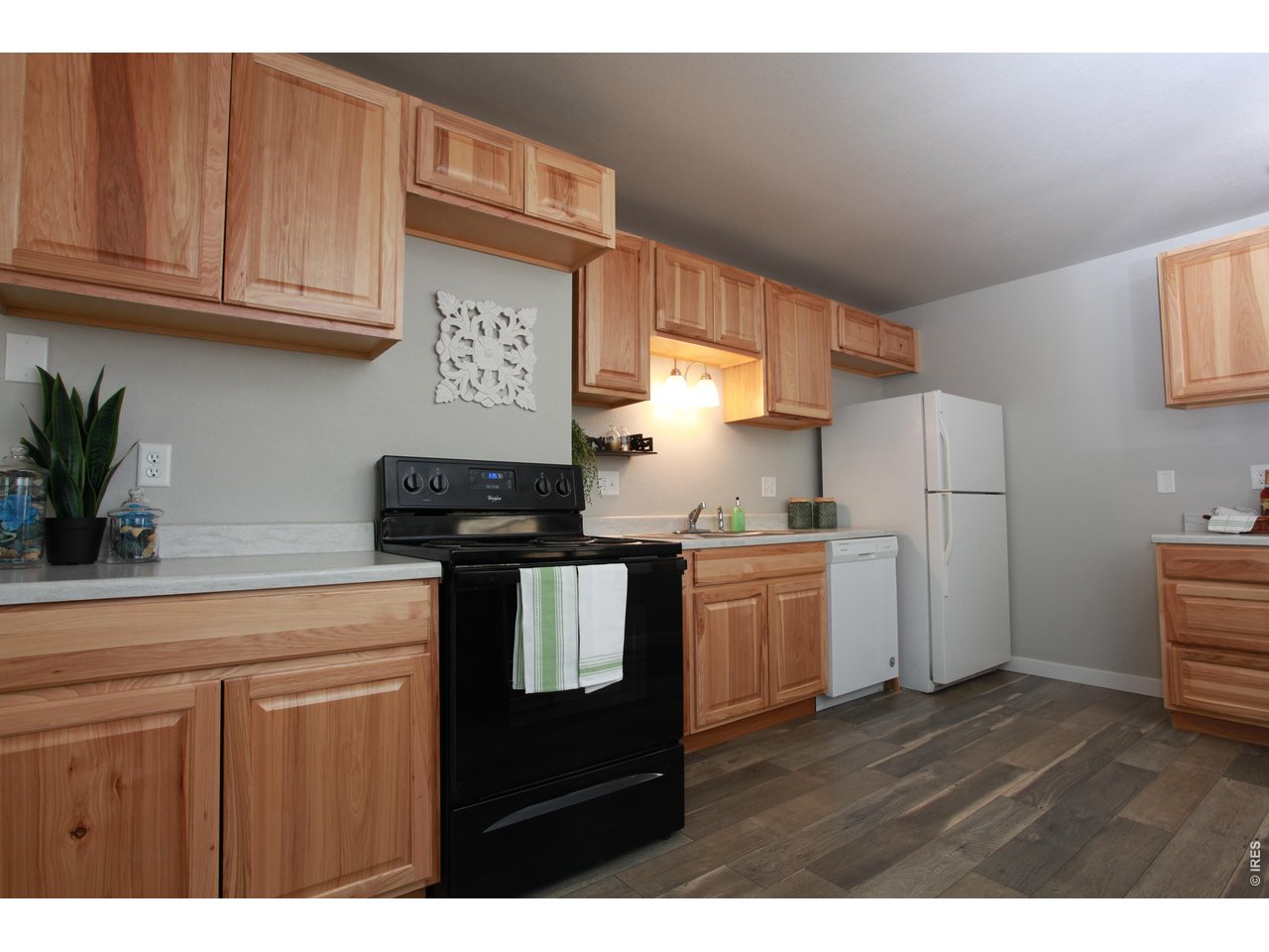 2908 West Olive Street Fort Collins, CO 80521 - Photo 6 of 20 a kitchen with a refrigerator and cabinets